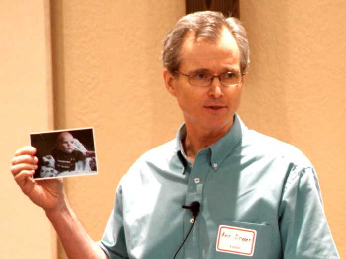 Guest Speaker Pastor Ken Draper showing his new grandchild's photo before preaching
 "If You Want to Please God..." - 8/29/10